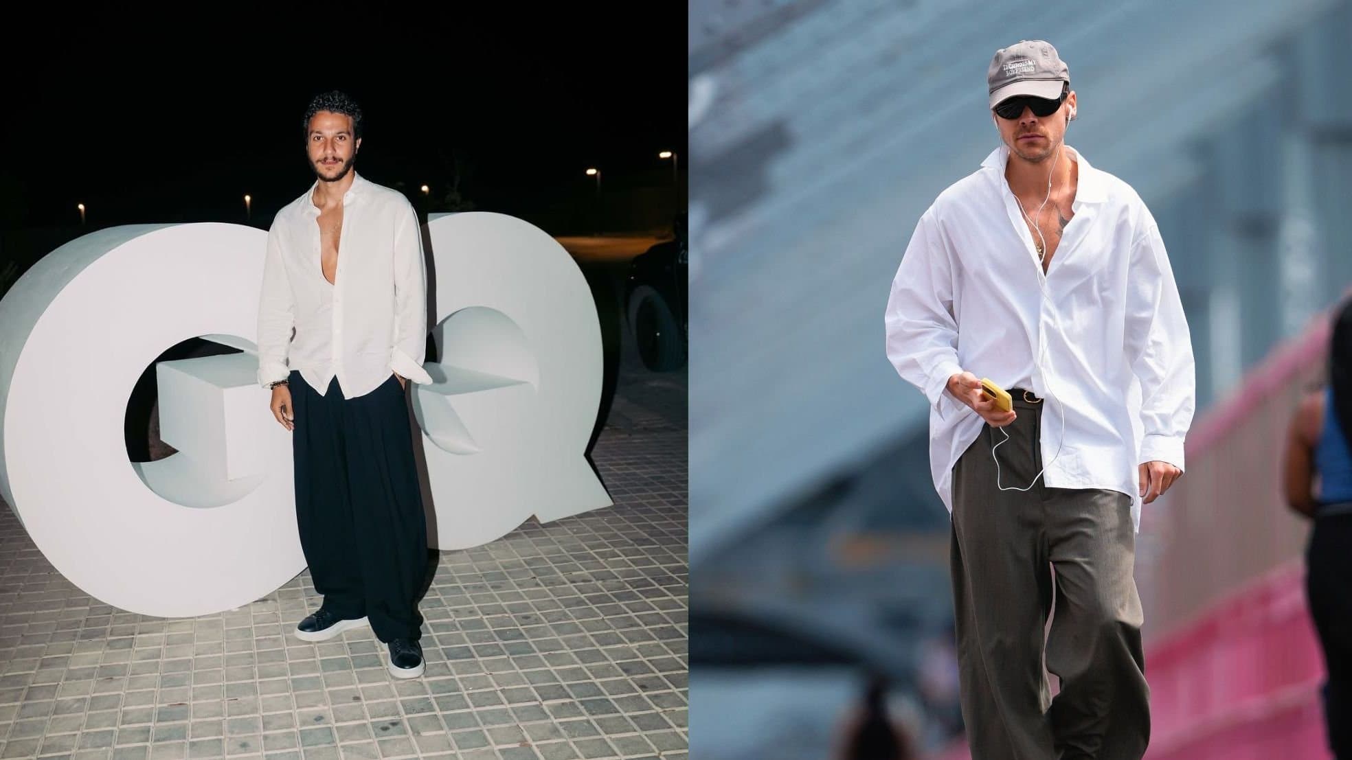 A man in an oversized white button-down shirt and baggy trousers walking on a city street